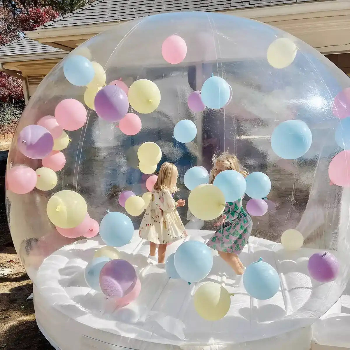 Adorable girls enjoying their best birthday party in the bubble bounce house