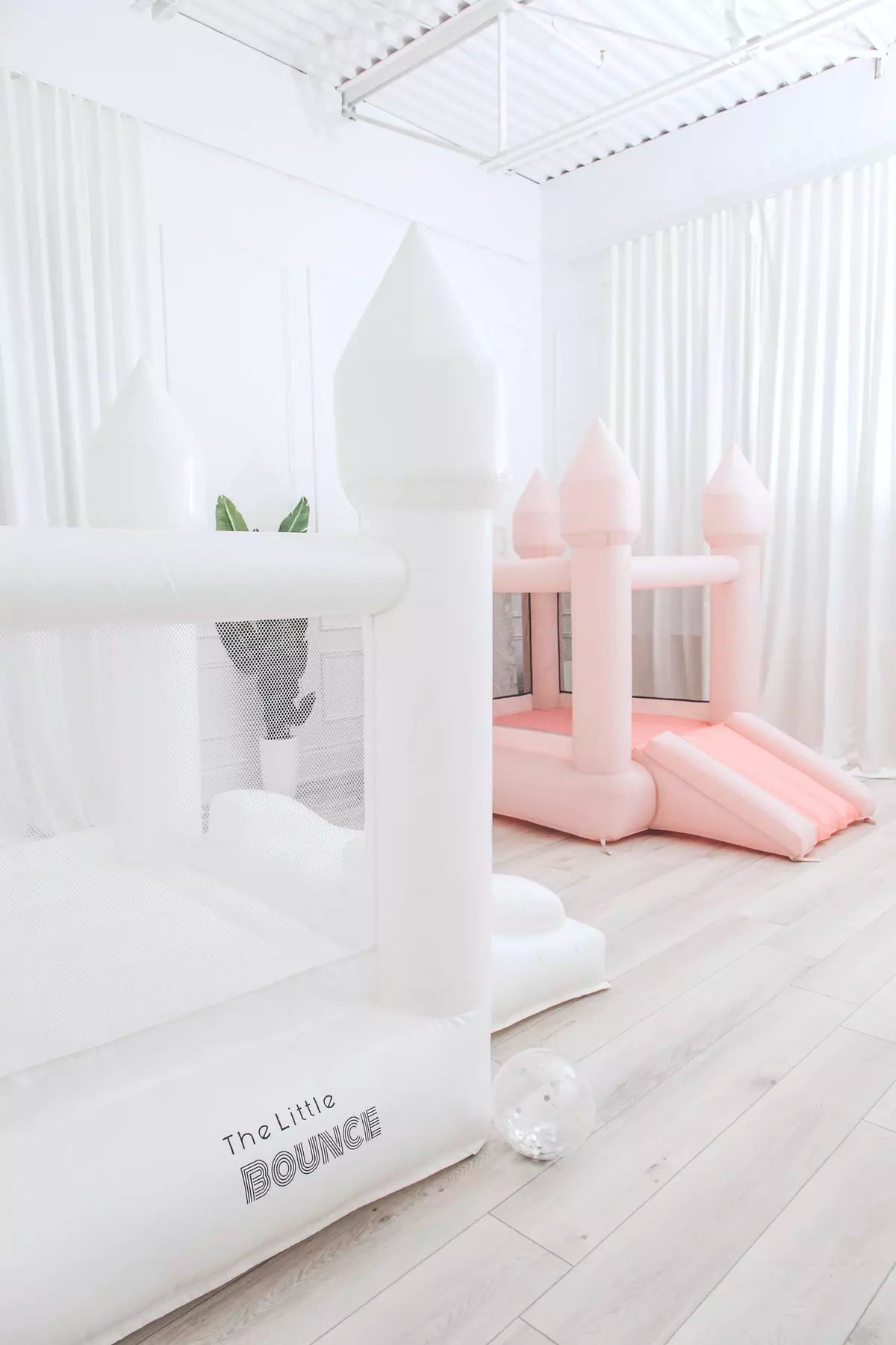 The Little Bounce, white small bounce house, and Pastel Little Bounce, pink small bounce house.