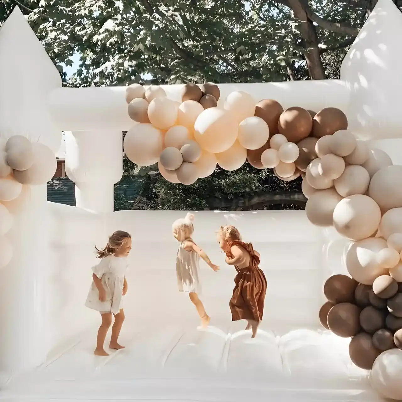 happy kids jumping on the mini white bounce house