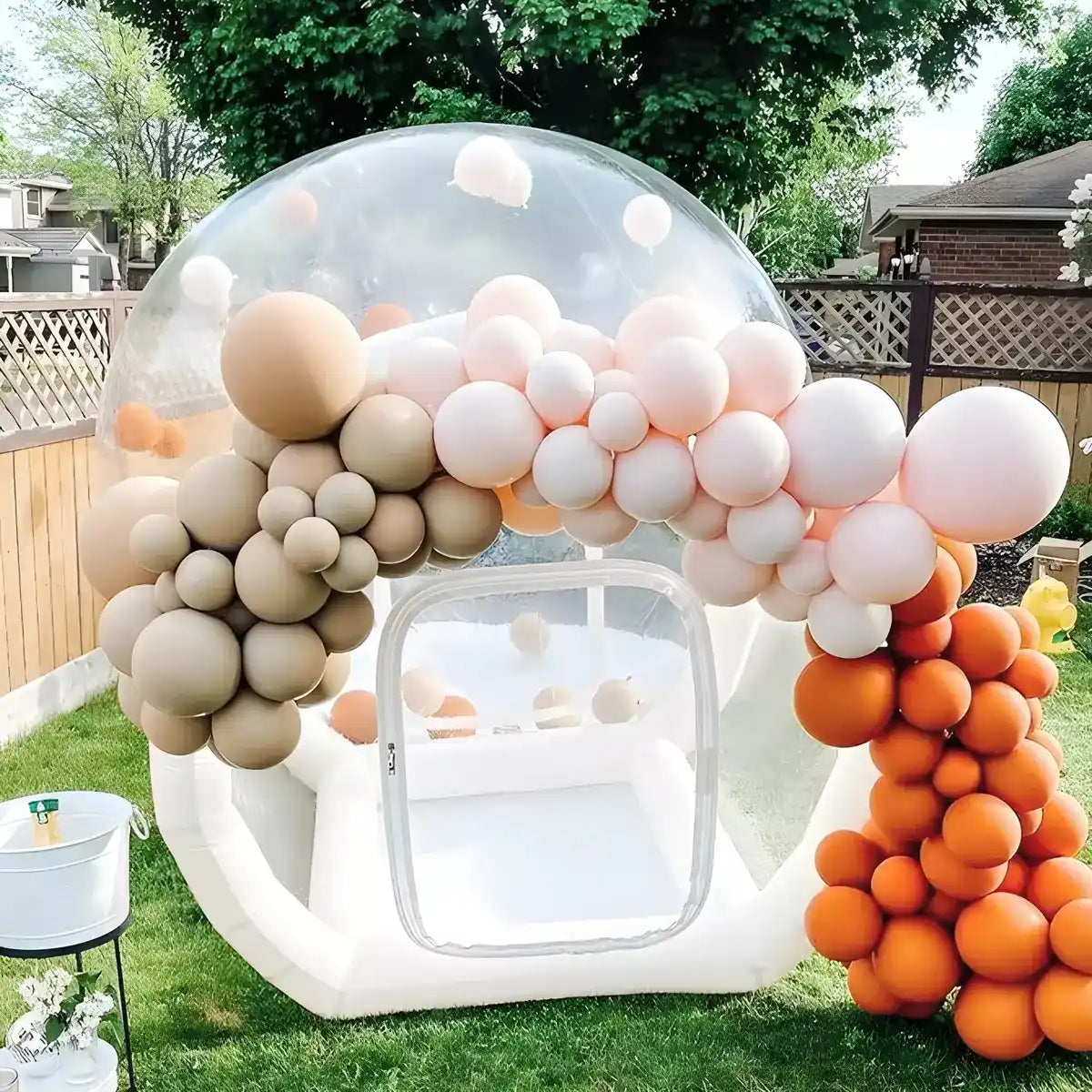 Inflatable bubble house decorated with balloons in backyard