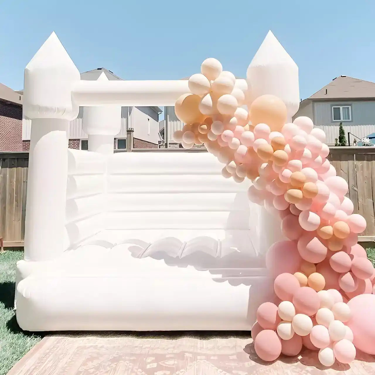 mini white bounce house with balloons