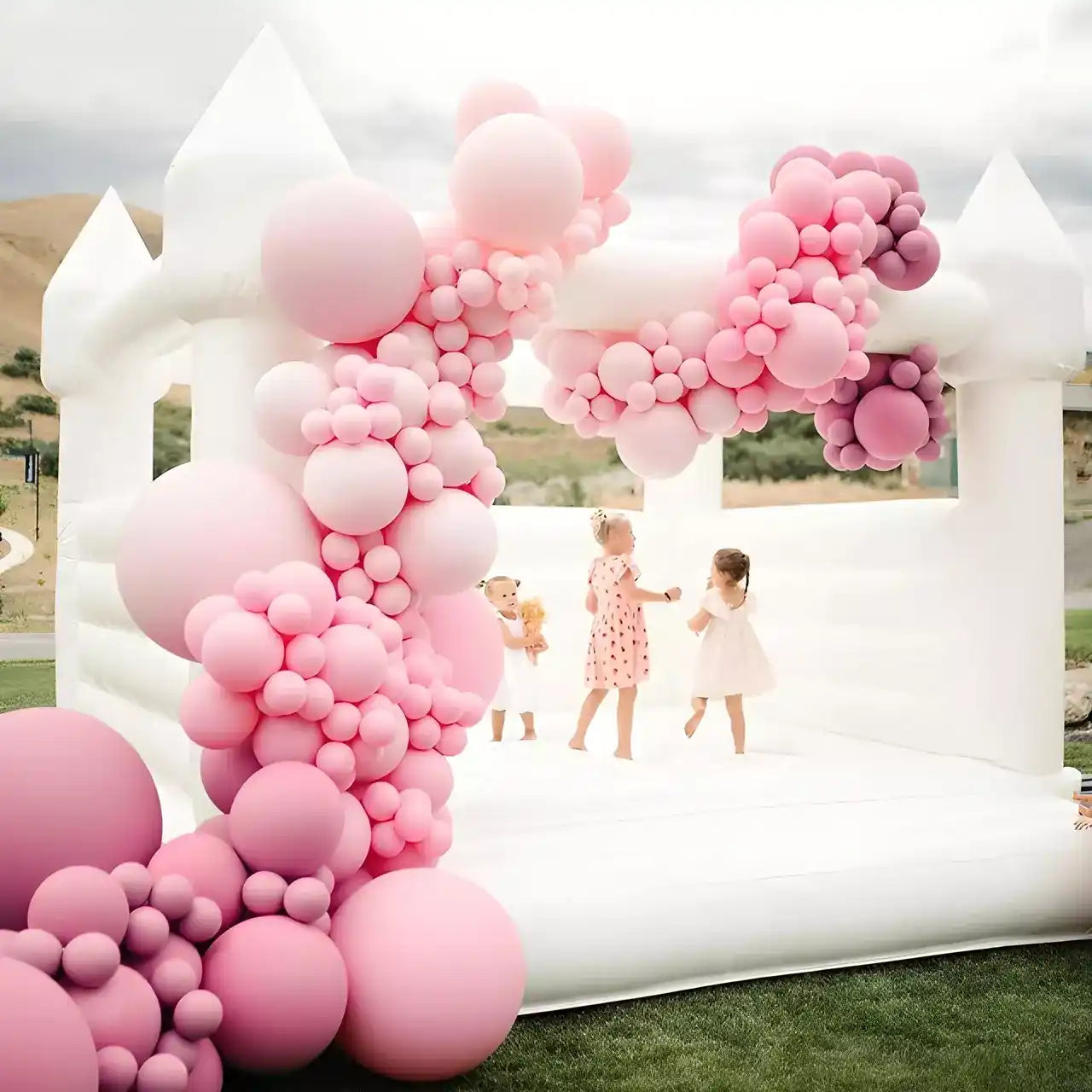Outdoor white bounce house for dreamy kids birthday party