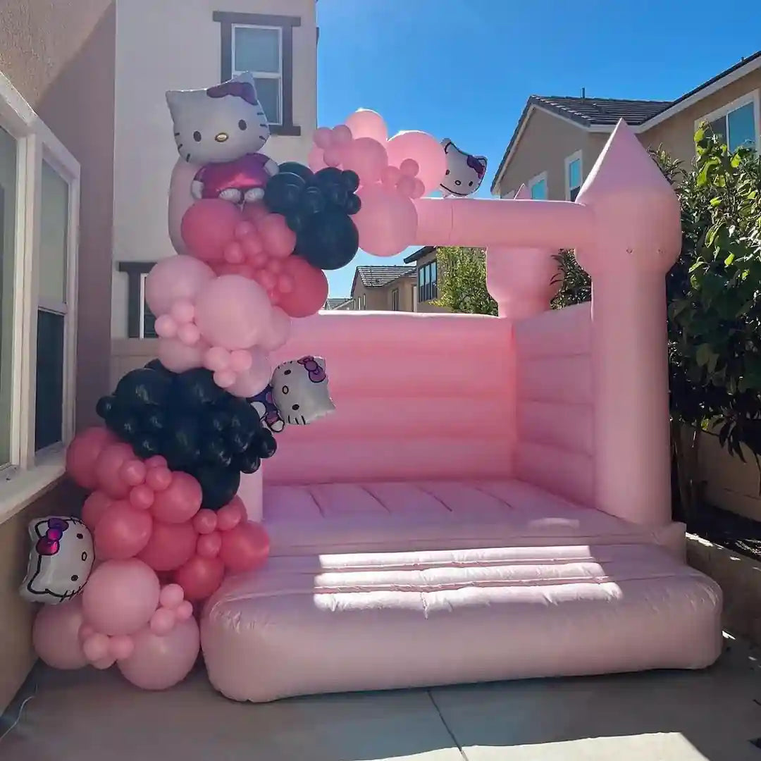 compact bounce house in pastel pink perfect for backyard party