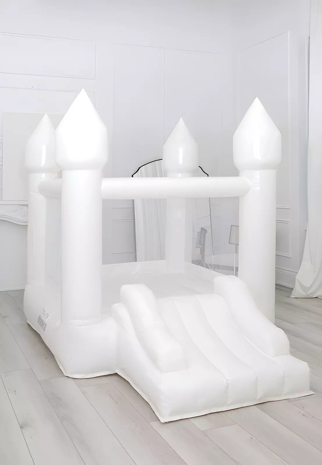 The Little Bounce, small white bounce house, placed inside a living room