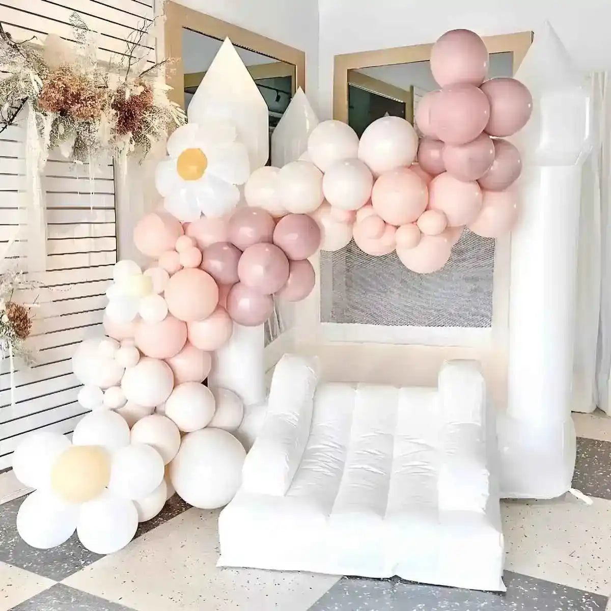 The Mini Bounce, mini white bounce house, decorated with pink balloons for party.