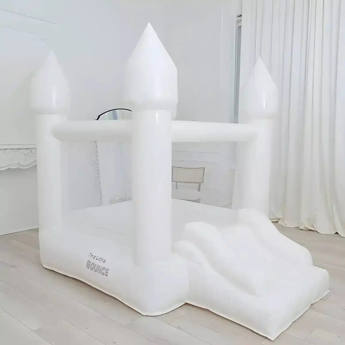 The tiny white bounce house placed in a living room