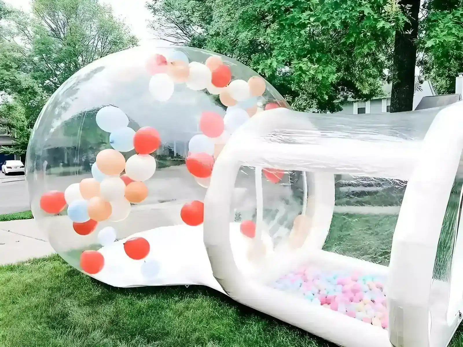 The Bubble House, transparent inflatable bubble tent, placed in the front yard with pit balls
