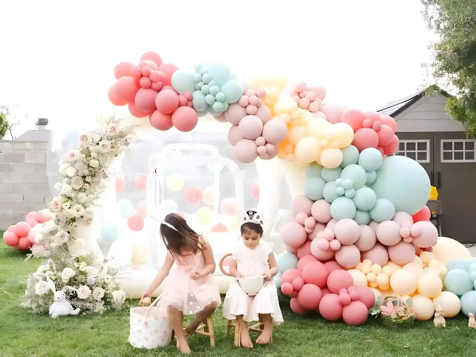 The Bubble House, transparent inflatable bubble tent, decorated with beautiful balloons in the backyard with kids posing in front